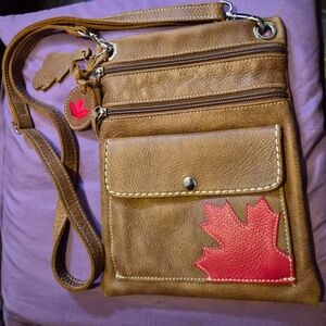 Roots Brown Leather Urban Pouch Tribe Crossbody Bag with Red Leaf Accent